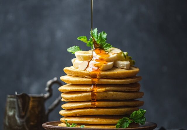 Sweet Delight: Drizzling honey over perfect pancakes Sweet Delight: Drizzling honey over perfect pancakes